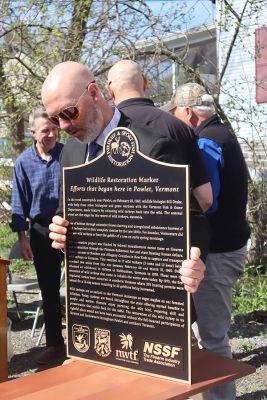 Commissioner Batchelder with the wildlife restoration marker.